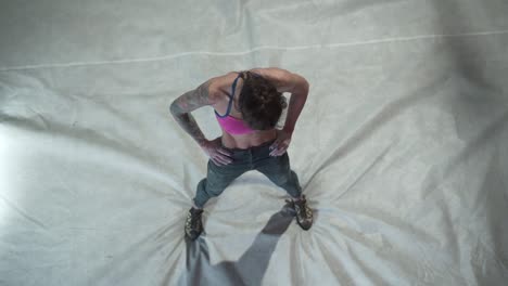 Woman Stretching in Climbing Gym