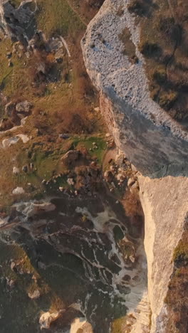 aerial view of a rocky cliff face and surrounding landscape