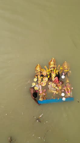 immersion of durga idols in river during durga puja festival