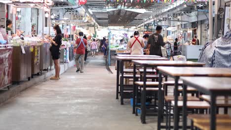 shoppers walking through a busy indoor market