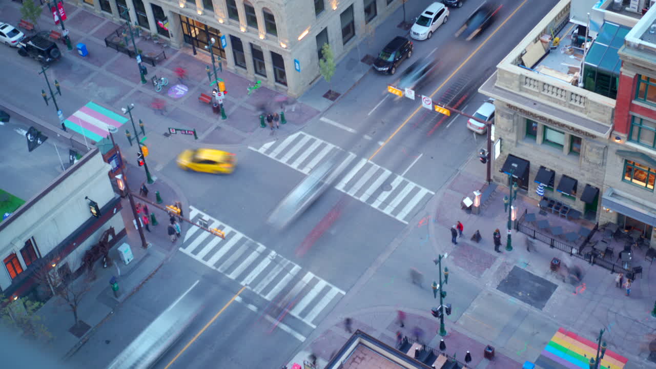 Time lapse of downtown street where people are moving and shadows are changing.