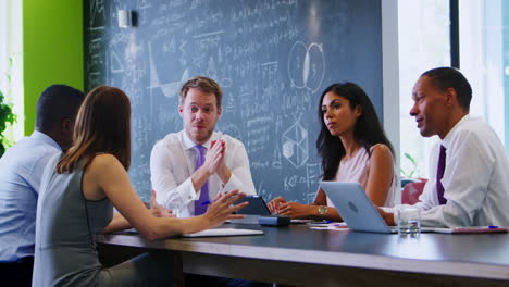 male boss talks to business colleagues at informal meeting