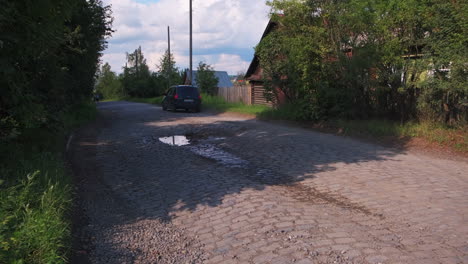 country road with pothole and car