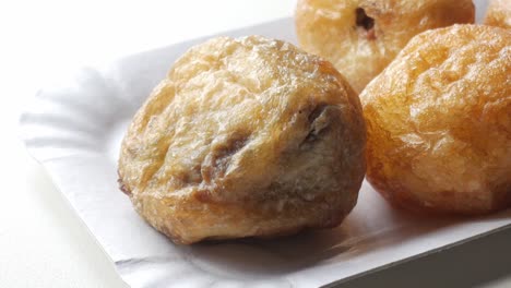 traditional spanish sweet recipe, buñuelos de viento. fritter dough balls with delicious stuffing like chocolate, vanilla custard, or crystallised fruit