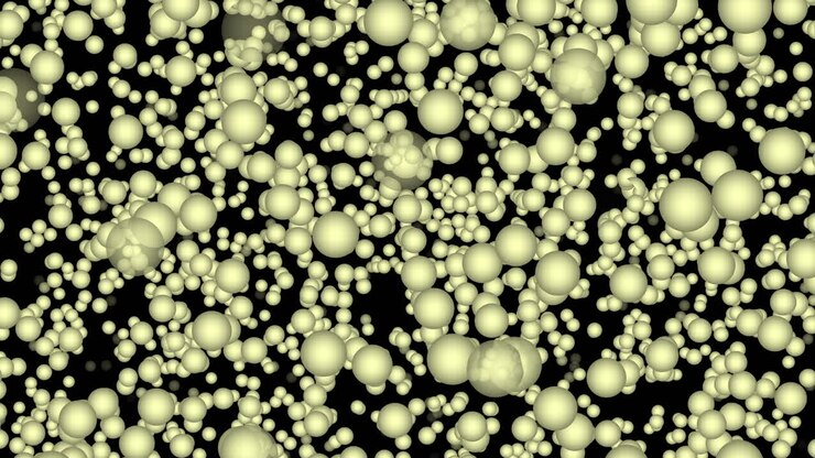 Particelle sferiche di medie dimensioni, strettamente impacchettate, che passano e svaniscono casualmente su sfondo nero