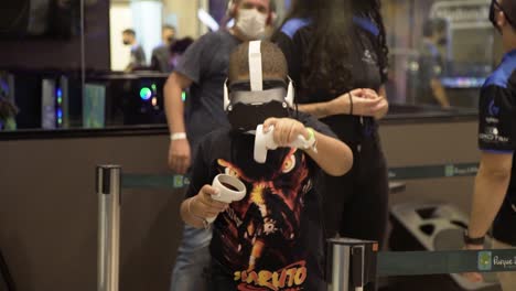 boy wearing a naruto shirt and playing virtual reality vr