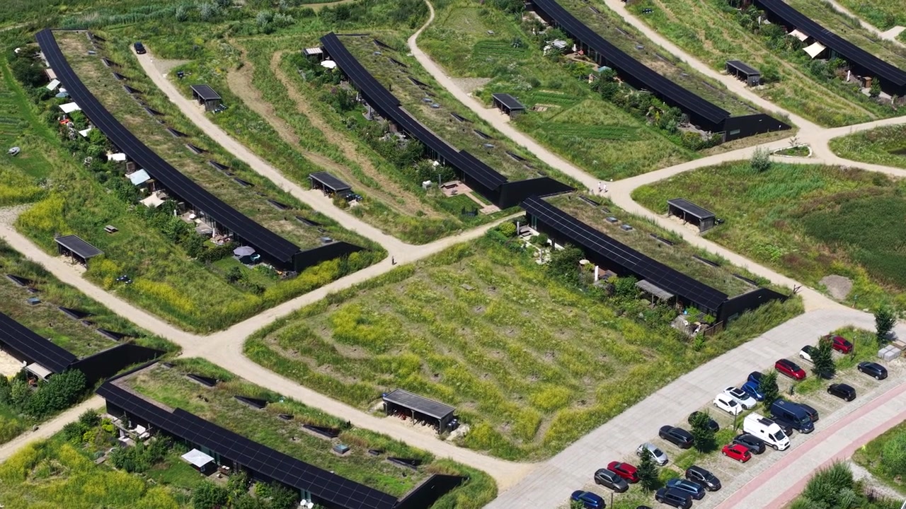 Aerial view of Ecovillage in Almere, the Netherlands, showing sustainable homes, biodiverse landscaping, nature inclusive architecture and climate adaptive residential design.