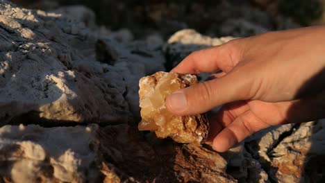 holding mineral rock in nature, calcite crystal stone in natural environment