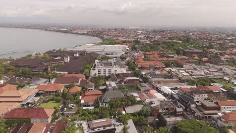 stunning aerial view of kuta, bali. flying over beachfront homes and scenic coastline. experience the beauty of this iconic tropical paradise in 4k.