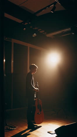 acoustic guitarist in recording studio
