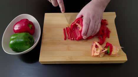 mano del chef corta finamente pimiento rojo