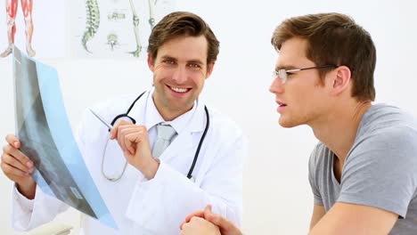 Young-doctor-discussing-xray-with-his-patient