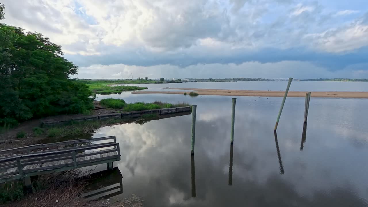 View of decaying dock and clouds on the Raritan Bay in South Amboy, NJ
