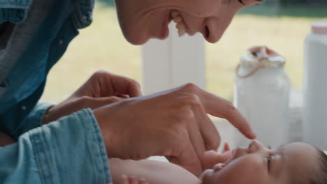 close up mother caring for baby on changing table happy mom playfully soothing toddler nurturing her child at home 4k footage