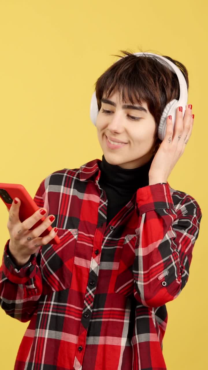 Young Woman Enjoying Music with Headphones and Smartphone