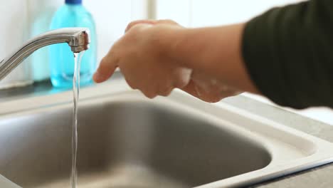 Caucasian-woman-washing-her-hands-with-soap-at-home