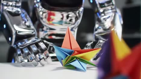 a futuristic robot interacts with colorful origami creations, showcasing the intricate craftsmanship of paper folding and advanced robotic technology in a contemporary setting