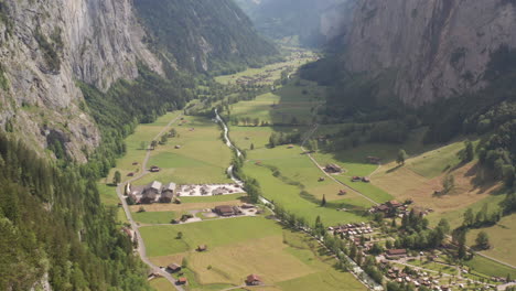Jib-down-of-beautiful-green-valley-with-a-small-town