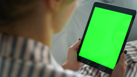 Girl-calling-chroma-tablet-closeup.-Unrecognized-woman-talking-friend-on-sofa.