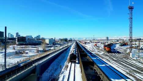 rail yard covered in snow on a bright sunny day