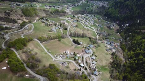 French-Alps-mountainside-village-on-hillside,-aerial-view