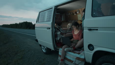 woman working on laptop in camper van