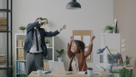Happy Business Colleagues Celebrating Success in Modern Office