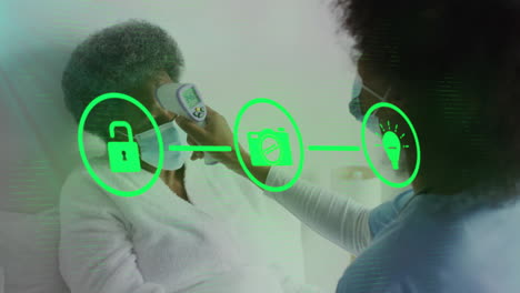 healthcare worker checking patient temperature in room with floating padlock camera lightbulb icons