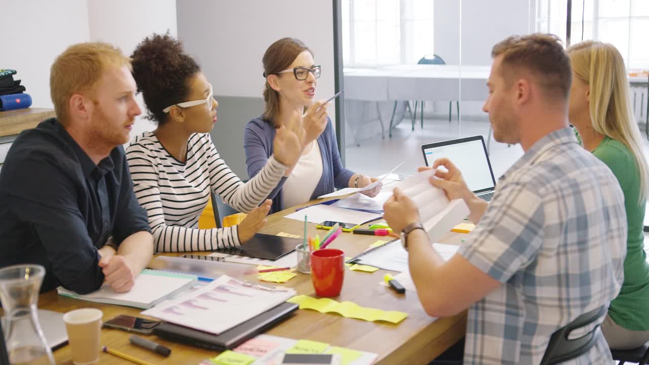 Coworkers at table with documents