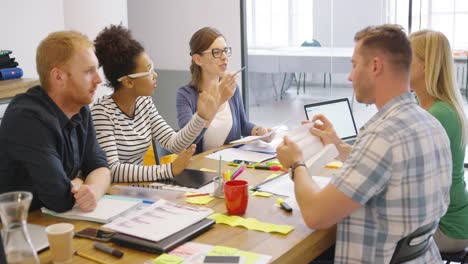 coworkers at table with documents