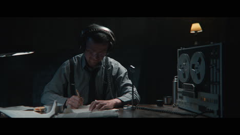 An intelligence officer listens to the wiretap recordings
