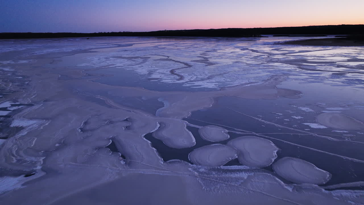 A drone's viewpoint exploring the intricate world of gigantic ice floes on the water at sunrise