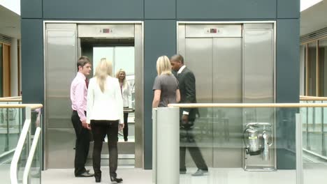 business people using a lift in building