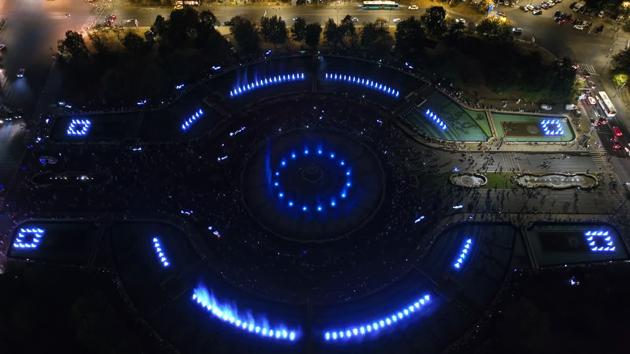 Aerial drone view of the illuminated Bucharest fountains in Romania, at night