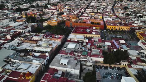 Aerial-view-revealing-the-Templo-de-San-Francisco-church,-sunset-in-Queretaro-city,-Mexico