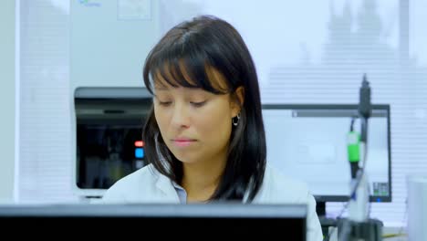 female scientist working on desk 4k