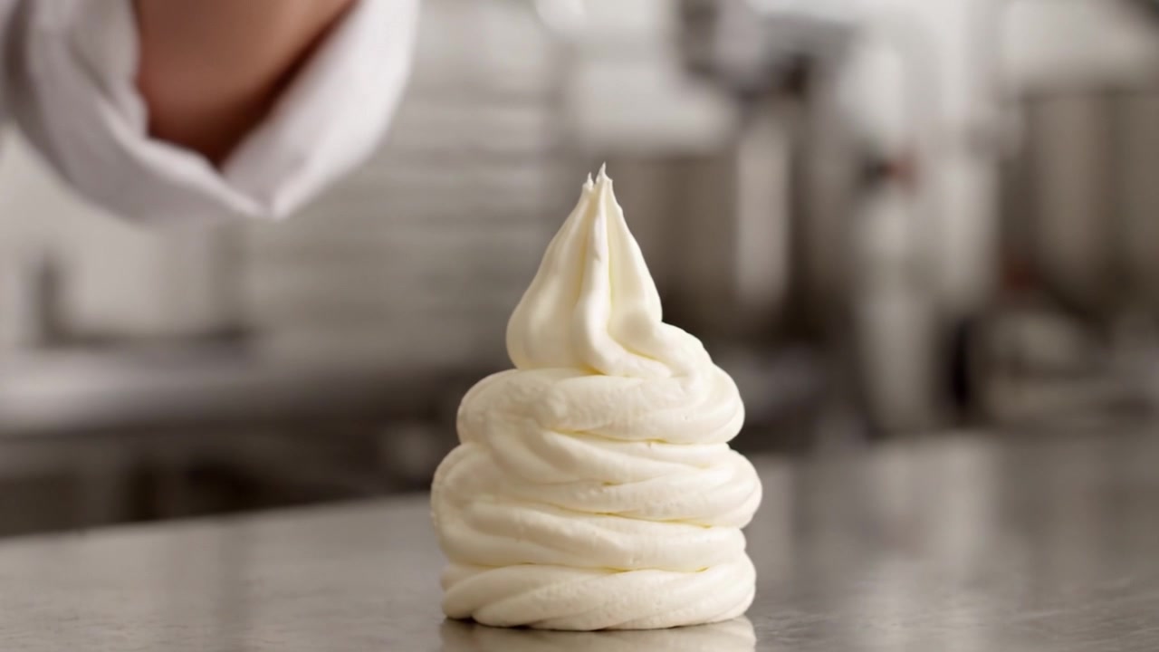 Expert Baking Techniques: The Art of Piping Creamy Frosting into Beautifully Swirled Toppings for Desserts and Pastries in the Culinary Kitchen
