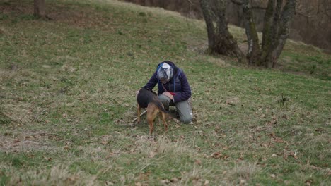 woman and dog in a field