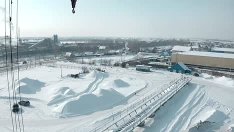 industrial site in winter with crane and snow