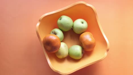 hand reaching for fruit in a bowl