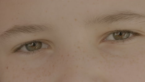 Closeup-on-pretty-brown-eyes-of-a-cute-teen-girl-gazing-into-camera