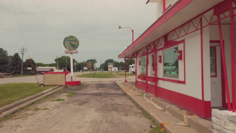 vertical camera movement until an old gas station along the lincoln highway comes into view