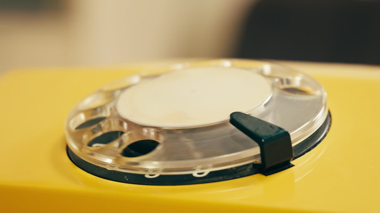 Retro vintage phone, A yellow rotary telephone is displayed on a wooden desk, adding a nostalgic touch