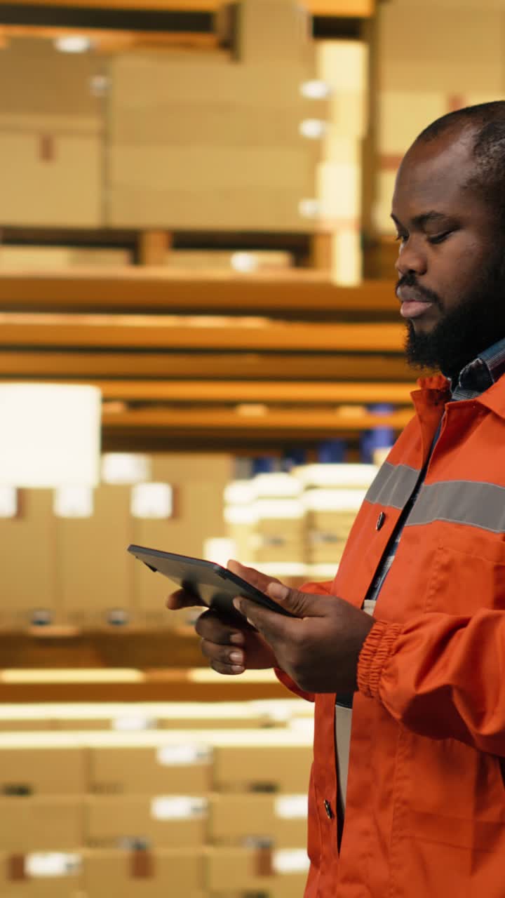 Vertical Video African American Worker Reviewing Inventory Data In Warehouse Distribution Hub