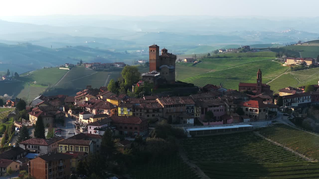 Aerial view of Serralunga d'Alba, highlighting its iconic medieval castle, charming village streets, and surrounding vineyards in the heart of Italy’s scenic Langhe wine region.