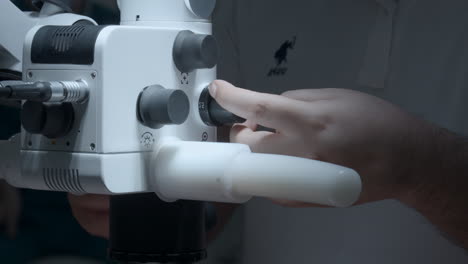 doctor adjusting a dental microscope