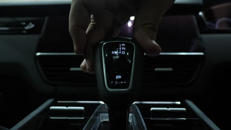 driver's hand changing gears in a semi automatic car