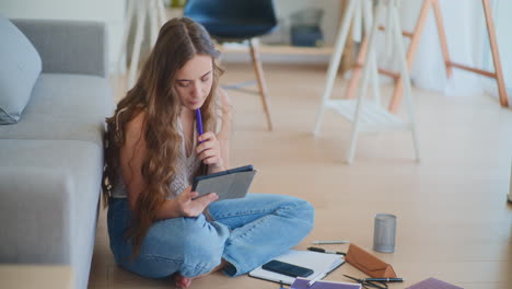 focused woman learning on tablet