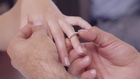 Man-placing-ring-on-womans-finger