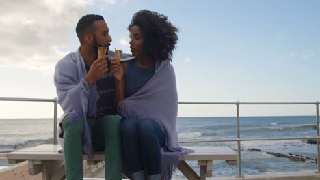 couple eating ice cream cone at beach 4k